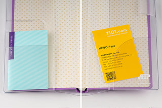 Clear planner cover open with turquoise memo and yellow card inside