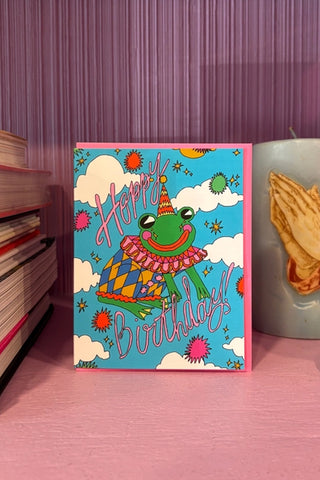 Birthday card with colorful cartoon dinosaur and “Happy Birthday” lettering