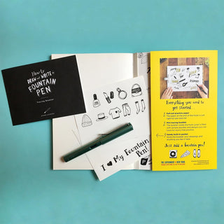 Fountain pen practice guide with open pages and green fountain pen