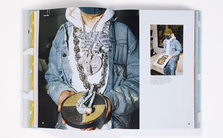 Open book page showing a person in denim jacket holding a patterned bag