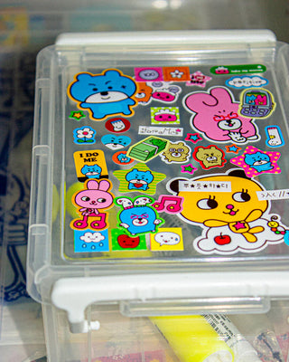 Colorful cartoon animal stickers in clear plastic organizer, featuring blue bear and pink rabbit