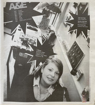 A black and white scan of a newspaper page from the Philadelphia Weekly of January 2007.   It shows young OMOI founder Liz Sieber in the original OMOI storefront on 1608 Pine Street. A starburst design on the page says >>Omoi Elizabeth Sieber imports Ts and trinkets from Japan. Feature, p.30.
