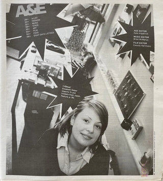 A black and white scan of a newspaper page from the Philadelphia Weekly of January 2007.   It shows young OMOI founder Liz Sieber in the original OMOI storefront on 1608 Pine Street. A starburst design on the page says >>Omoi Elizabeth Sieber imports Ts and trinkets from Japan. Feature, p.30.
