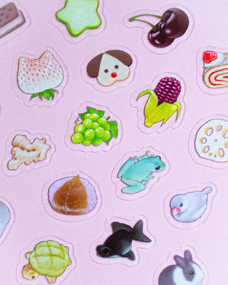 Close-up of clear stickers showing cute animals and fruits, die-cut shapes on film