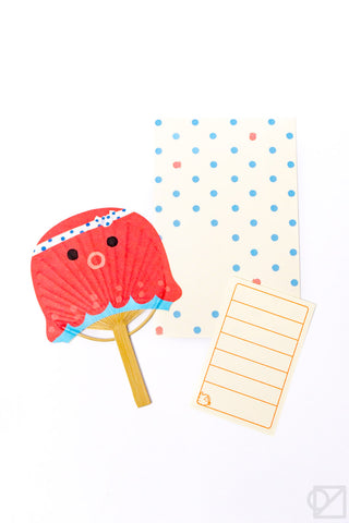 Greeting card showing red fan on beige card front with blue polka dots