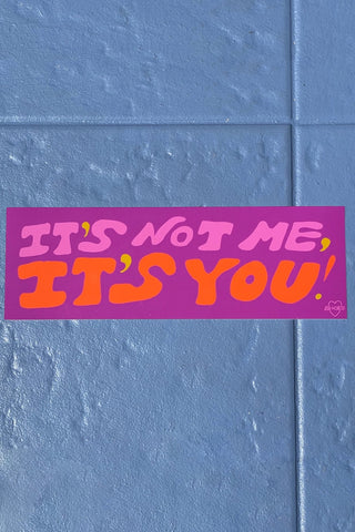Colorful bumper sticker with "It's not me, it's you!" text in pink, orange, and yellow.