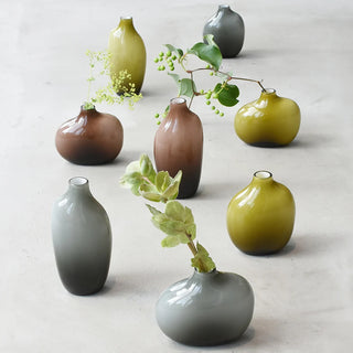 Brown matte glass vase with short neck, shown with other color vases
