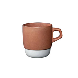 Ceramic 11 oz coffee mug with orange-brown body, white base, and side handle