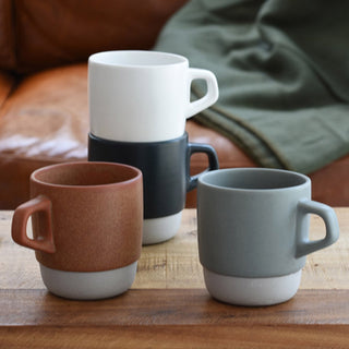 Ceramic stacking coffee mugs, white and dark blue-gray with curved handles