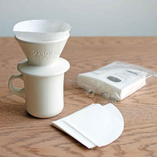 White folded 4-cup coffee paper filters with pack, for slow coffee brewing