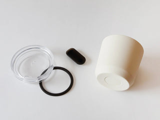 KINTO TO GO tumbler parts: clear lid, black cord, and plug component