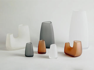 KINTO TRE glass vases lineup in smoke and amber with flared openings and tapered bodies.