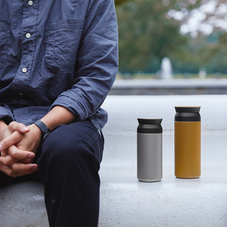 Two 500ml travel tumblers: light silver and mustard with black lids