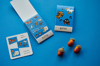 Stamp-style washi tape rolls with animal icons in blue and orange; includes label cards