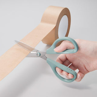 Teal nonstick scissors cutting paper with a hand grip