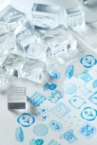 Clear stamp blocks with engraved designs and neon blue print patterns