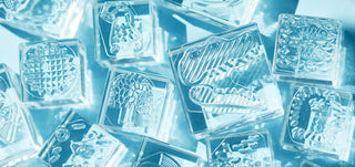 Close-up of clear engraved stamp blocks with textured geometric pattern details