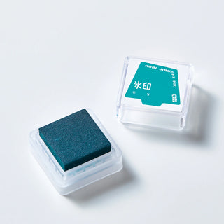 Two clear ink stamp pads with dark teal ink pads and teal label