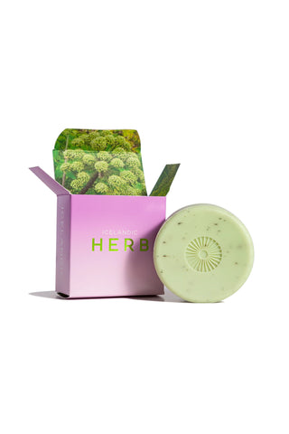 Green herb soap bar with open purple-pink gift box