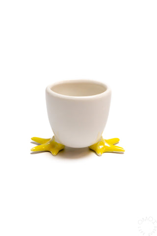 Egg soap cup with white cup, yellow star feet, and a yellow egg half on top