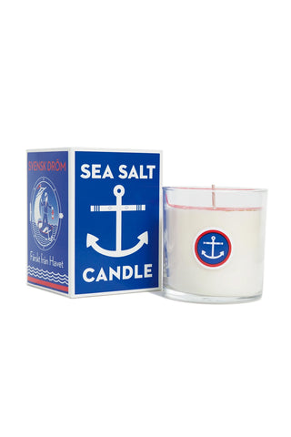 Sea salt candle in clear glass jar with red anchor label and matching box