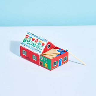 Red matchbox cottage house with colorful floral roof and open box with matches