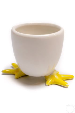Egg soap cup with white cup and yellow star feet, holding a yellow egg half