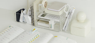 Sticky notes with pastel tabs in a desk organizer, mini clips included