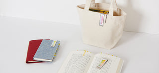 Pastel sticky notes sticking out from an open notebook