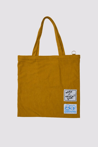 Mustard tote bag with Karepango sticker patch, Keep the joy note, back view.