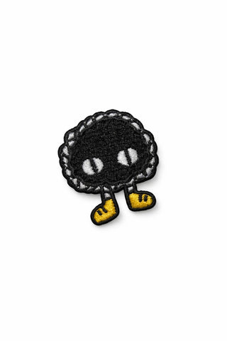 Small embroidered pin kit patch with black character and yellow boots