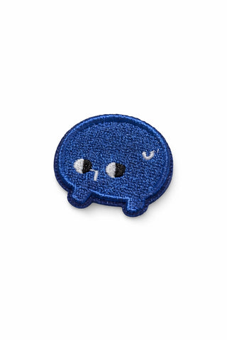 Small embroidered pin, blue speech-bubble face with white eyes