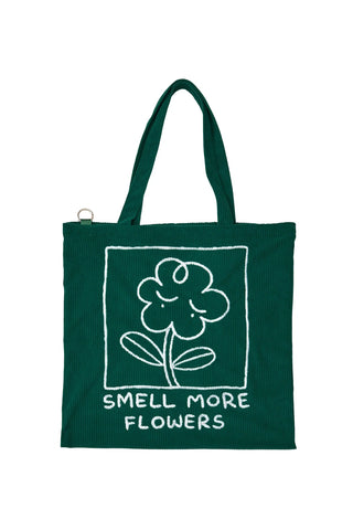Green tote bag with embroidered flower and 'SMELL MORE FLOWERS' front