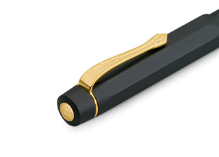Black pen cap end with gold clip and circular gold emblem on Kaweco