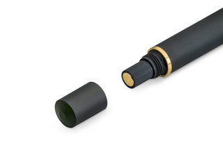 Black piston pen cap piece with gold threading ring and nib-end details