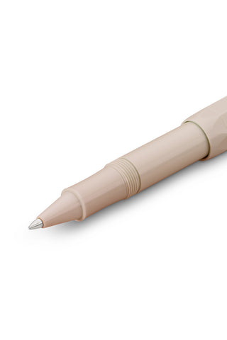 Light beige rollerball pen tip, close-up of pointed writing end