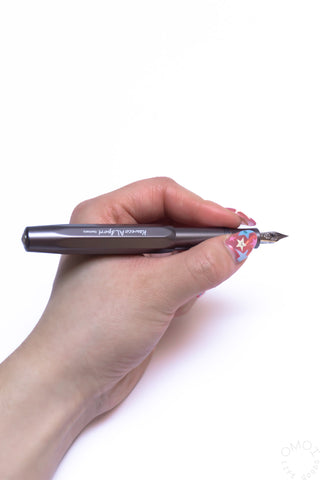 Anthracite fountain pen held in hand, silver nib and clip