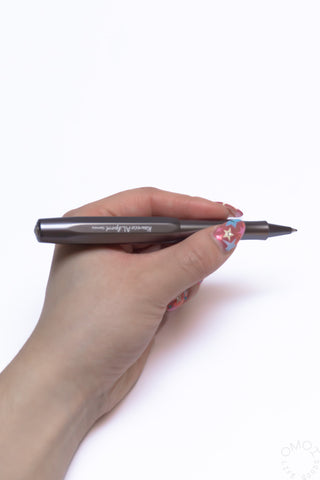 Anthracite rollerball pen held in hand with metal clip