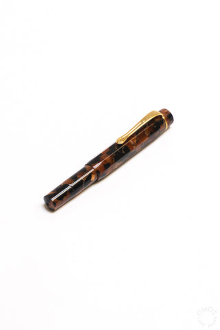Hickory brown tortoiseshell fountain pen with gold trim and nib, side view