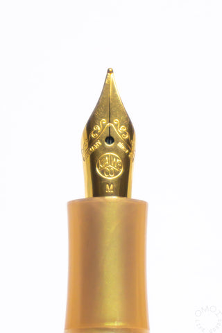 Gold fountain pen nib on an apricot Kaweco Collection Sport pen