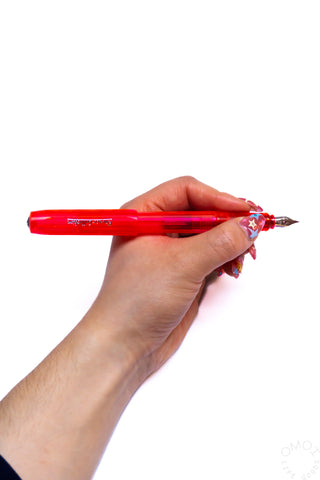 Kaweco PERKEO infrared fountain pen held in hand, red transparent barrel and nib