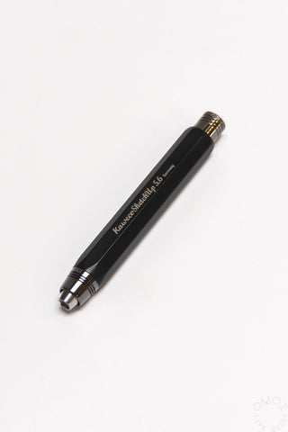 Black aluminum clutch pencil side view with printed markings and lead tip
