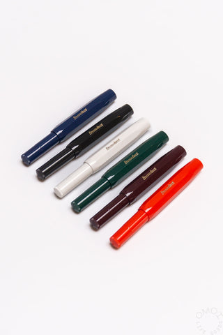Fountain pen assortment in navy, black, white, green, maroon, and red colors