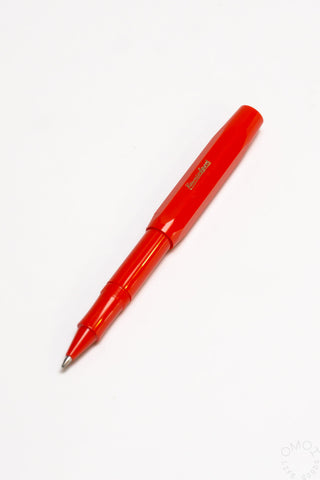Red rollerball pen with exposed metal nib and clip