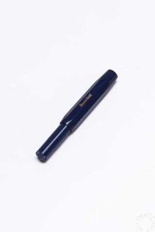 Navy blue fountain pen with gold nib and barrel label