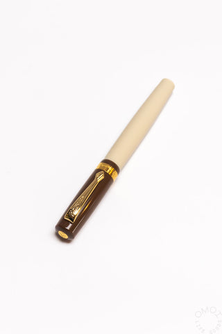 Cream fountain pen at angle, showing gold nib and clip