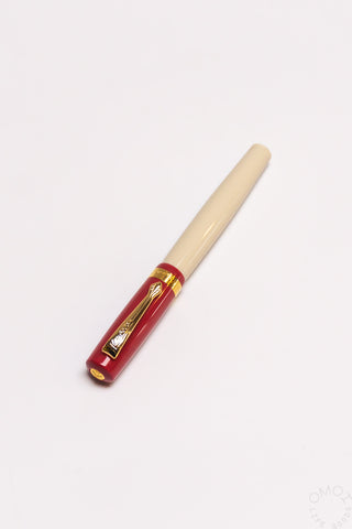 Red student fountain pen with medium nib, beige grip and gold nib hardware
