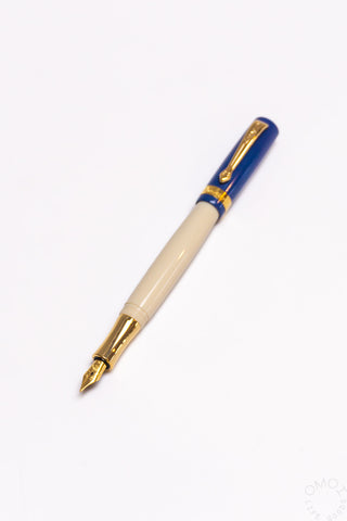 Blue student fountain pen with medium nib, beige grip section and gold nib hardware