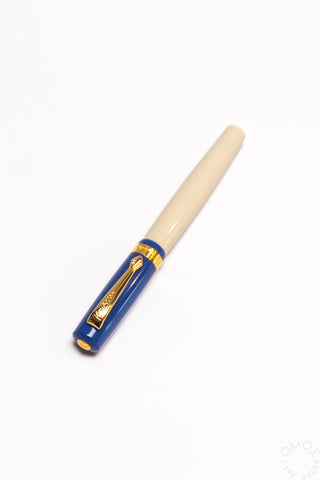 Blue student fountain pen with medium nib, beige grip and gold accents on barrel