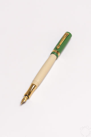 Green student fountain pen with medium nib, beige grip section and gold accents